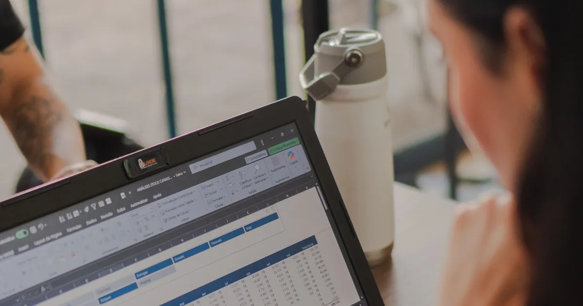 A marketer working on a laptop with spreadsheet data