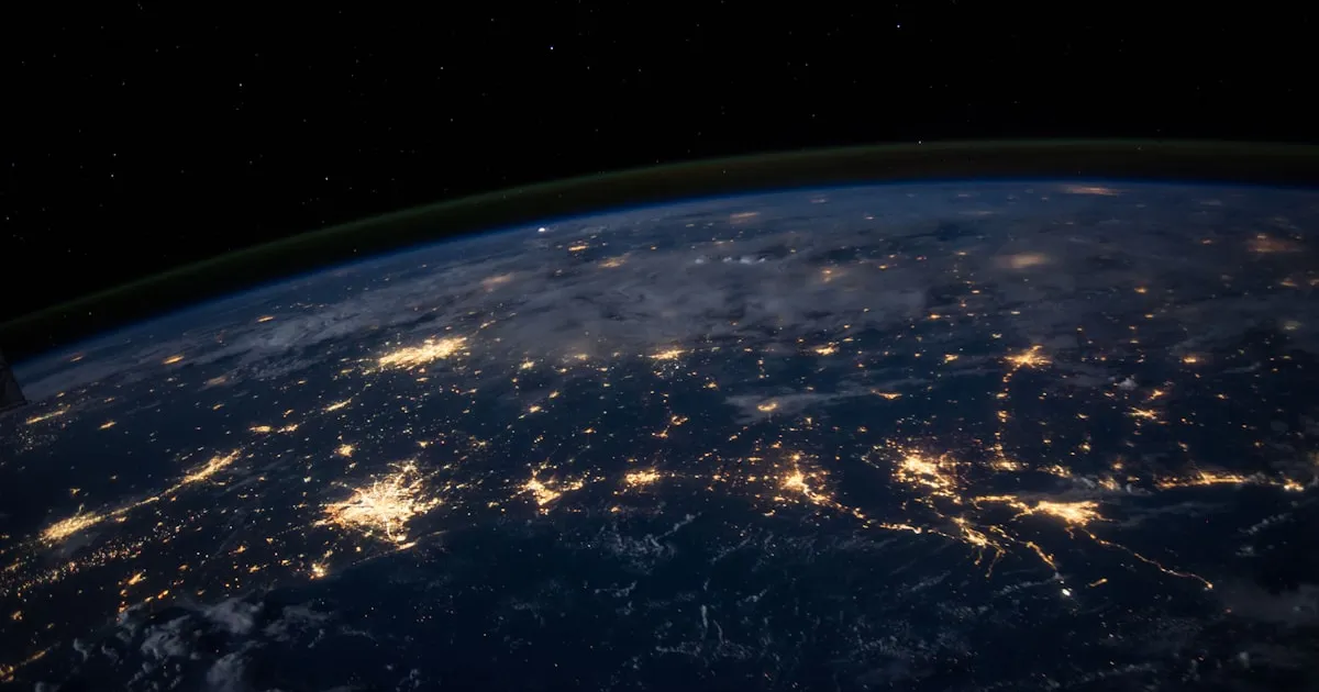A breathtaking view of the Earth from space with glowing city lights representing global data connections and geolocation