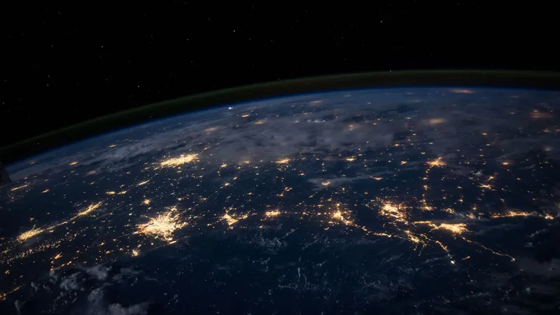 A breathtaking view of the Earth from space with glowing city lights representing global data connections and geolocation